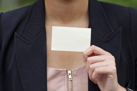 Asian woman holding a blank business card