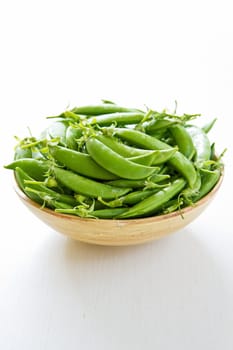 Fresh Sugar snap pea in wood bowl