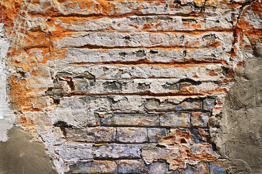 Grunge texture of old brick with plaster falls off in the background