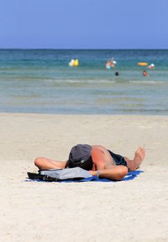 Playa de Palma, Spain, August 23, 2012: Photograph of man relaxing on a sunny summer day on Playa de Palma beach in Mallorca,Spain.