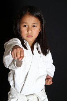 Cute asian small girl in kimono looking at the camera