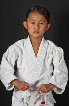 Cute asian small girl in kimono looking at the camera