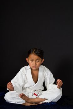 Cute asian small girl in kimono looking at the camera