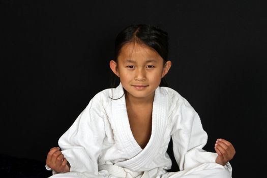 Cute asian small girl in kimono looking at the camera