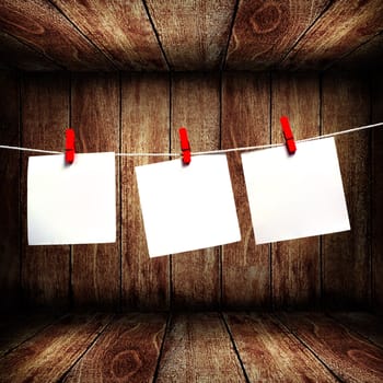 Blank note paper hanging on rope in wooden box