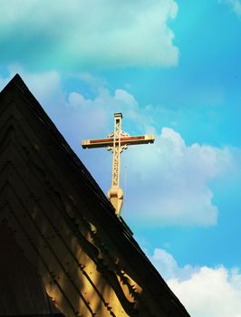 Wooden cross on a blue sky