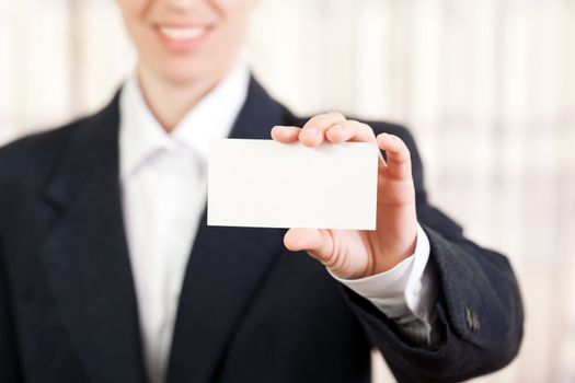 Smiling women hand holding white empty blank card