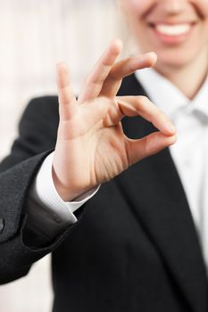 Business women hand gesturing OK or success sign