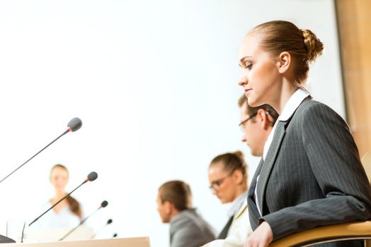 businessmen communicate at the conference, sitting at the table, on the table microphones and documents