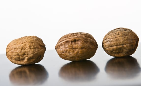 Many nuts placed on a reflecting surface