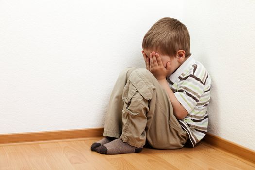 Little child boy wall corner punishment standing