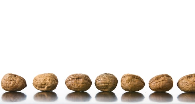 Many nuts placed on a reflecting surface