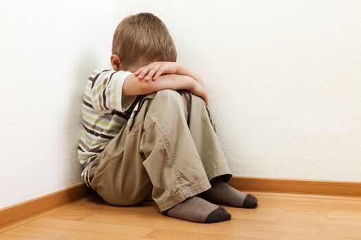 Little child boy wall corner punishment standing