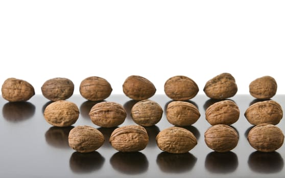 Many nuts placed on a reflecting surface