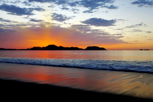 Purple skies and flowing water at sunset in Guanacaste