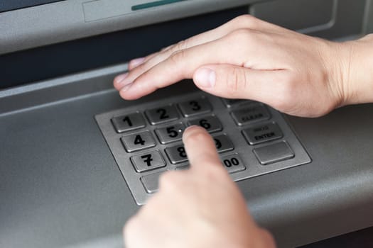 Human hand enter atm banking cash machine pin code