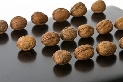 Many nuts placed on a reflecting surface