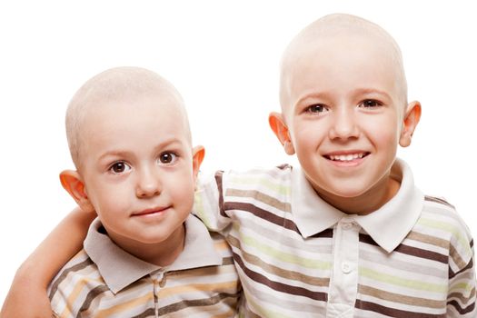 Family happiness - two little smiling child boy brothers with bald shaved heads