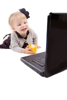 Baby girl playing with laptop over white