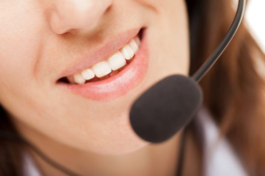 Smiling business woman with headphones or headset