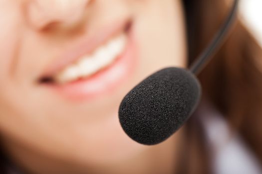 Smiling business woman with headphones or headset