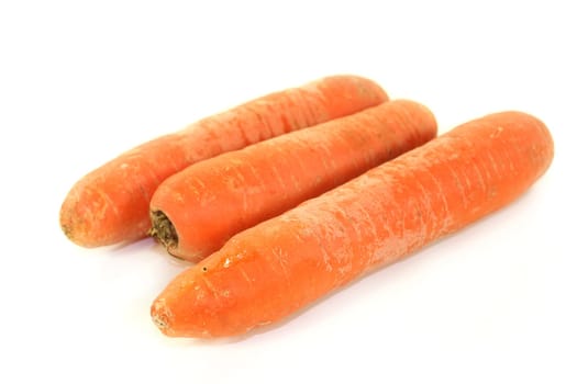 raw carrots in front of white background
