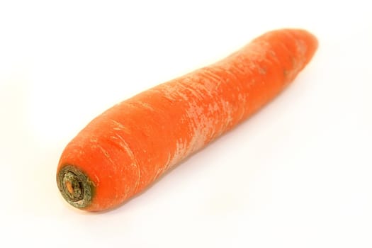 a raw carrot in front of a white background