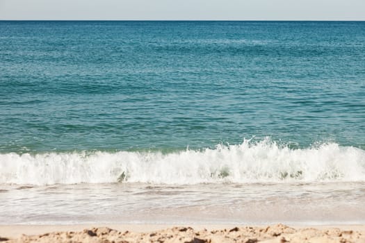 Summer vacations - blue water waves on tropical sea sand beach