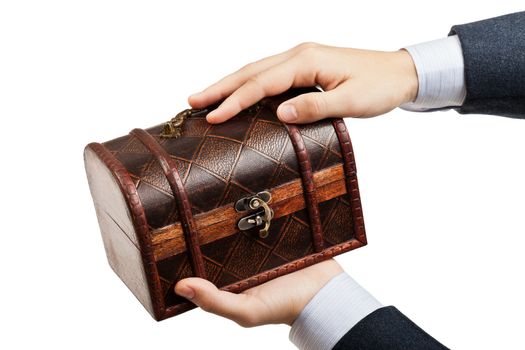 Business man hand holding old antique brown wood treasure chest or box white isolated