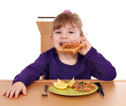 little girl eat toast bread and tuna fish for breakfast