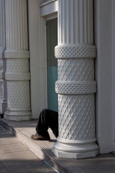 Man sitting in doorway on the street of Portland, Oregon.