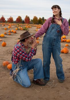 Scarecrow flirts with farmer's wife or daughter.