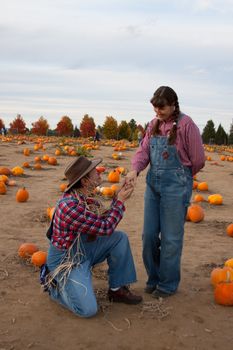 Scarecrow flirts with farmer's wife or daughter.