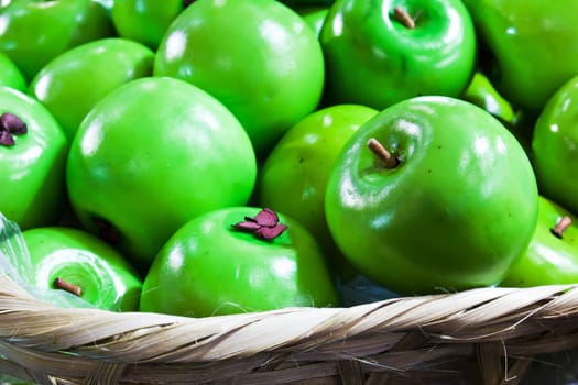 Fake green apple in basket