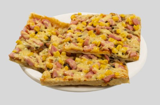 3 slices of pizza with cheese, sausage, corn and mushrooms on white plate, side view.