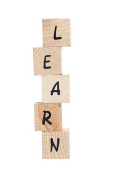 Learn spelled out with wooden blocks. White background.