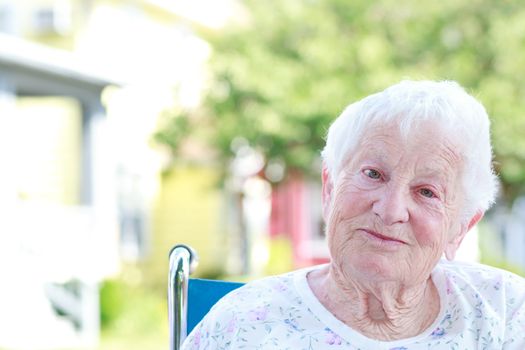 Happy Senior Woman in a Wheelchair Outside