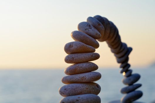 Bending arc of the pebbles on the seashore