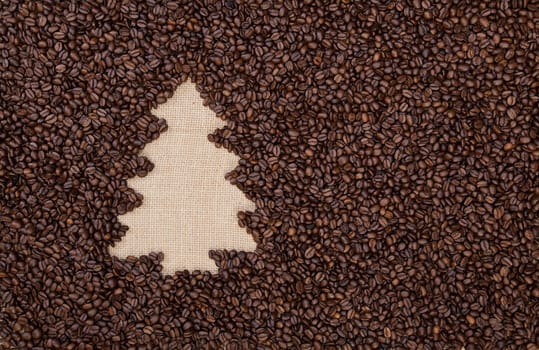 Fir tree made of roasted coffee beans on burlap