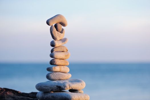 Pile of pebbles each other on a sea boulder