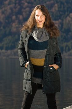 Model with the latest fashion this fall with lake in background