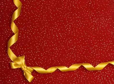 A ribbon and bow on a red background, christmas present background