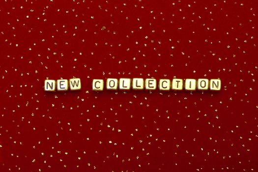 photo of words "new collection" of beads on a red velvet with sequins