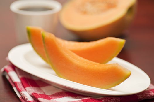 Wedges of fresh cut delicious cantaloupe photographed closeup.