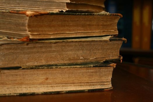 books on table in dark library room