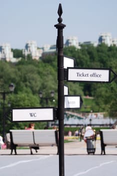 directional  arrow sign in a city park crossroad 