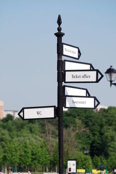 directional  arrow sign in a city park crossroad 