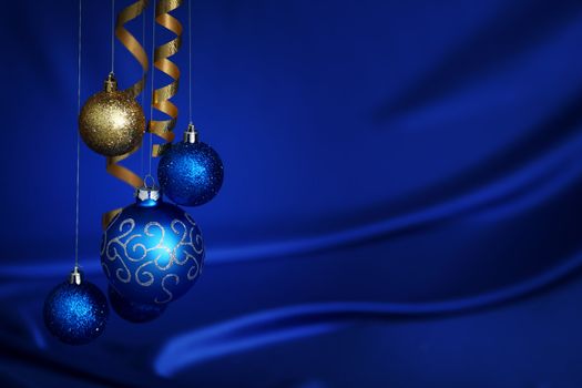 christmas balls on blue satin background
