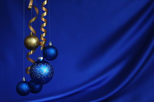 christmas balls on blue satin background