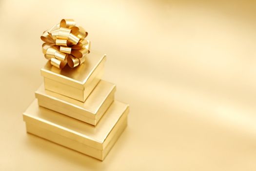 golden christmas gifts on gold background 